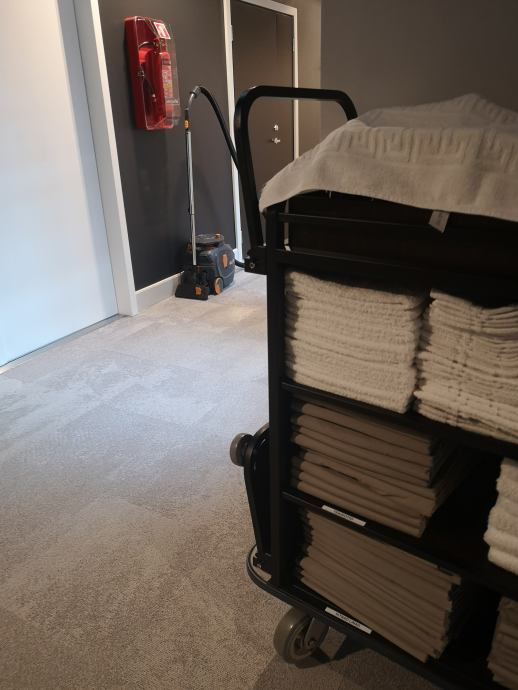 Cleaning trolley is standing in the hotel corridor