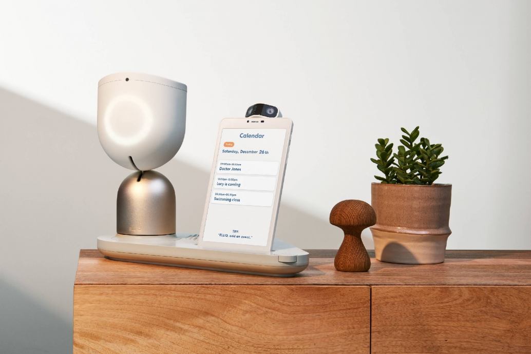  picture of ElliQ care robot for the elderly, the bedside table has a small robot and a screen with reminders for daily activities, such as taking medicine.