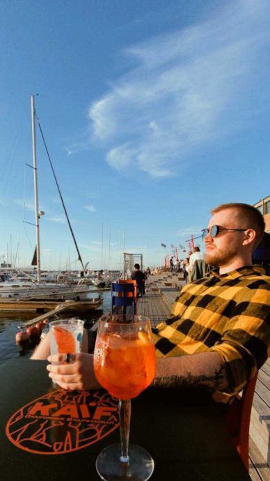 Priit enjoys the moment in an outdoor café with a cocktail