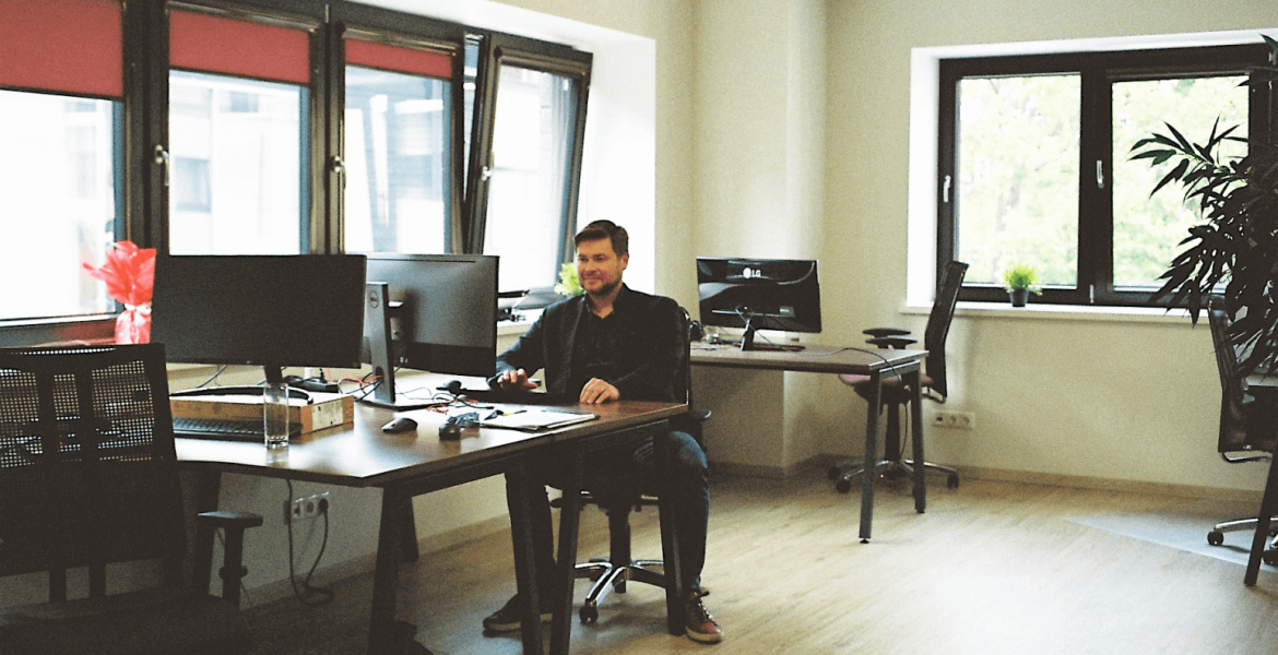 Kaur sitting at a desk in the Intelex Insight office