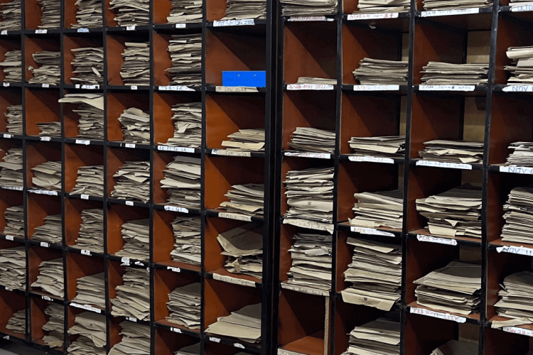Paper documents on shelves